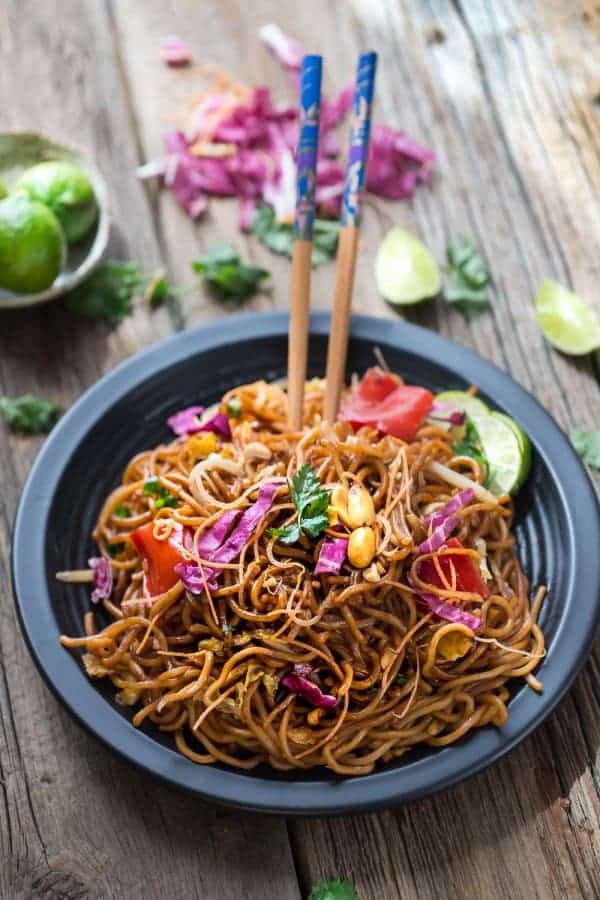 Rainbow Asian Skillet Peanut Noodles in a black bowl with chopsticks