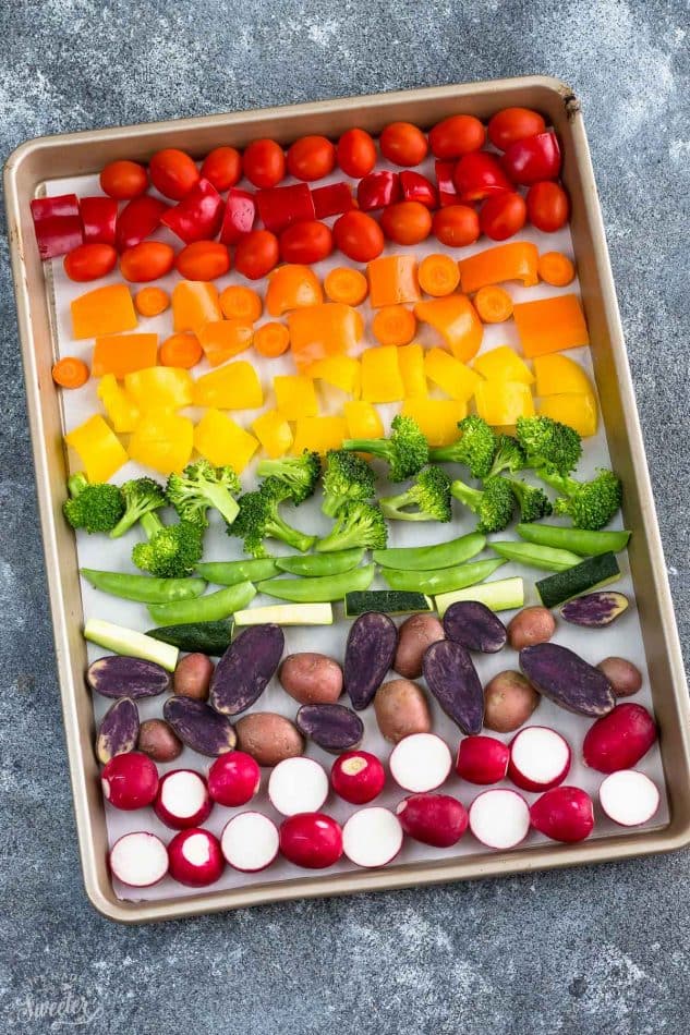 Top view of raw Rainbow Vegetables on a sheet pan