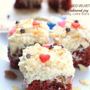 Close-up view of Red Velvet Almond Joy Bars topped with coconut