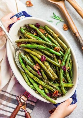 Roasted Green Beans with garlic, balsamic, lemon pepper pecans (and optional cranberries) is the perfect simple recipe to enjoy fresh green beans. This recipe is fancy enough for Thanksgiving, Christmas, or Easter holiday meal, and easy enough for a weeknight side dish! #sidedish #Thanksgiving #christmas #healthy #balsamic #garlic #roasted #vegetables #healthy #keto #paleo #lowcarb