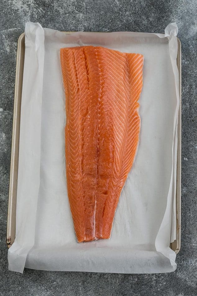 Raw Salmon on a Baking Sheet Lined with Parchment Paper