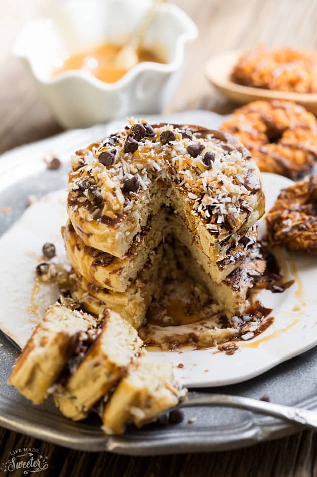 These Samoa Pancakes are the perfect way to enjoy the popular Girl Scout Cookie all year round. Best of all, these soft and fluffy pancakes are so easy to make with layers of toasted coconut, melted chocolate and gooey caramel.