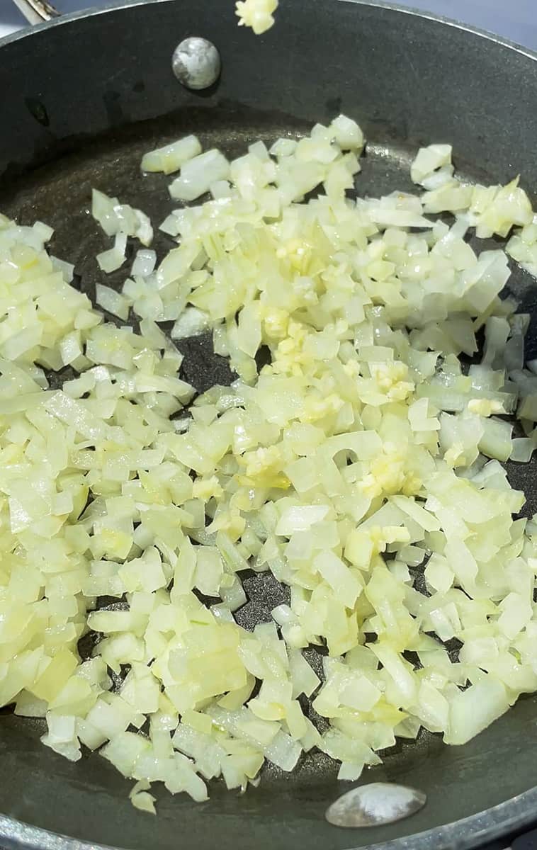 Sautéed diced onions and garlic in an oiled nonstick pan