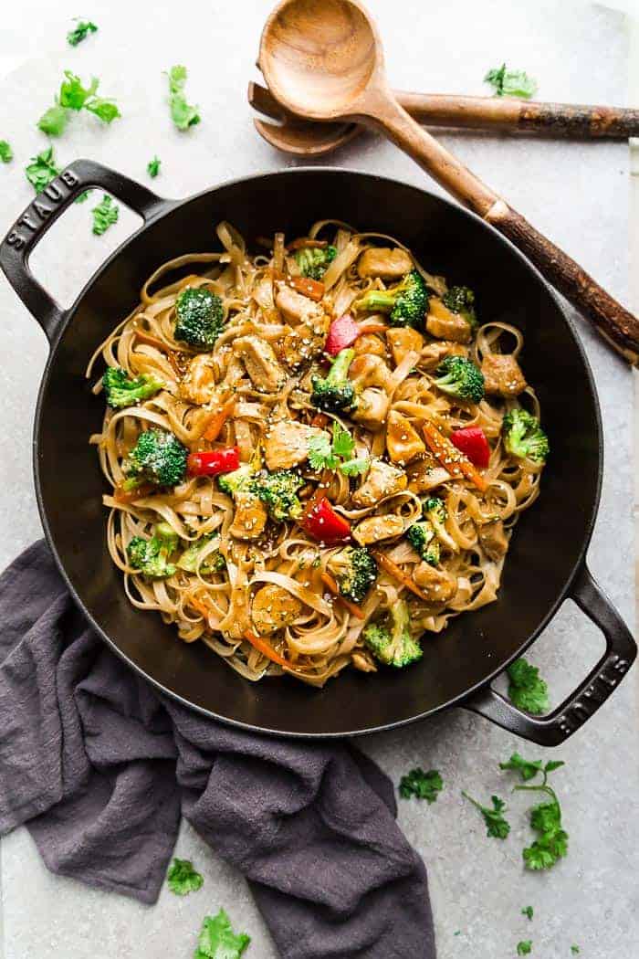 Asian Sesame Chicken Noodles - a one pot 30 minute meal perfect to curb those takeout cravings. Made with chicken, veggies, gluten free rice noodles and a delicious savory Asian-inspired sauce.