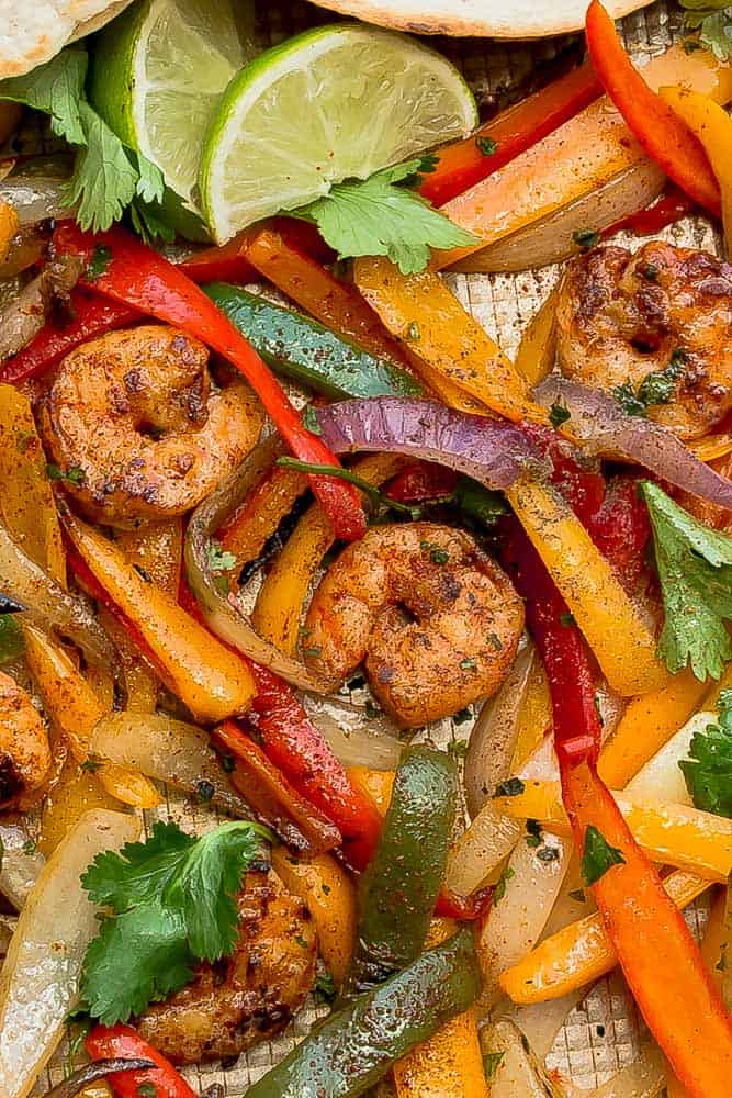 Close up of shrimp fajitas on a pan with bell peppers