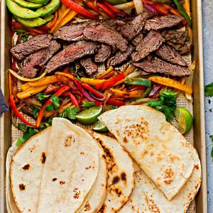 Sheet Pan Steak Fajitas are tender, juicy and full of flavor and perfect for busy weeknights! Best of all, options for low carb and keto with a homemade fajita spice blend and cilantro lime marinade.