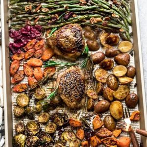 Sheet Pan Turkey Dinner For Two - an easy and healthy one pan Thanksgiving meal for two (or four). Best of all, everything cooks up in under an hour. Includes a juicy turkey, potatoes, green beans, carrots, sweet potatoes and cranberries. 