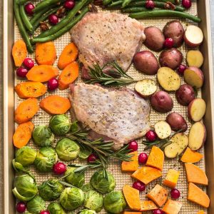 Sheet Pan Turkey Dinner For Two - an easy and healthy one pan Thanksgiving meal for two (or four). Best of all, everything cooks up in under an hour. Includes a juicy turkey, potatoes, green beans, carrots, sweet potatoes and cranberries. 