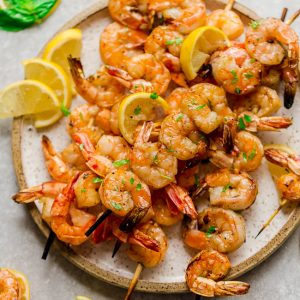 Grilled Shrimp Skewers with Lemon Herb Butter Sauce - seasoned with a fresh and flavorful citrus herb combo for the perfect light and tasty low carb dish for summer parties, lunches and dinners. Best of all, just a few ingredients and only 20 minutes to make.