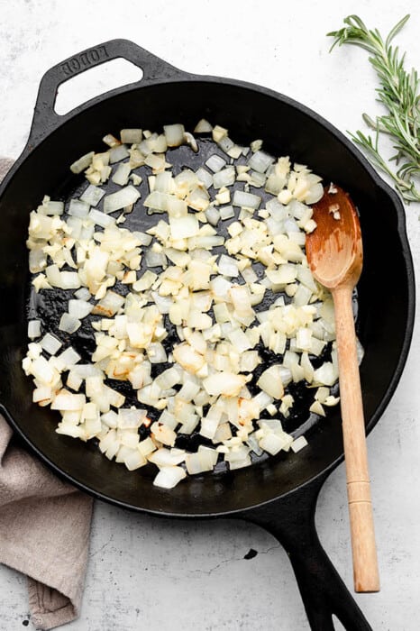 Diced onions being sauteed in a skillet