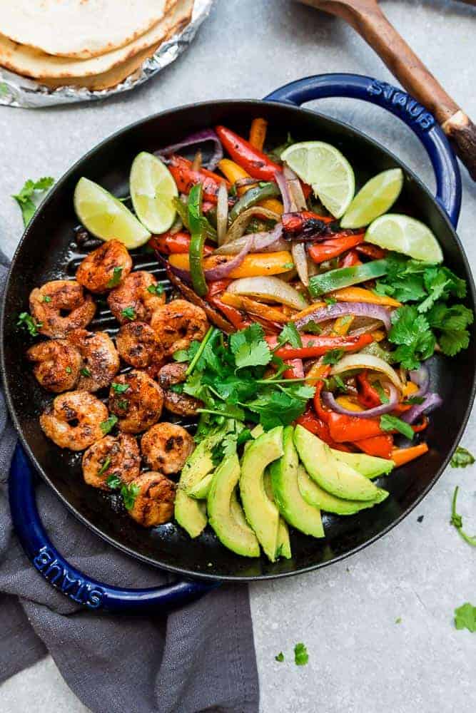 Skillet Shrimp Fajitas - the perfect easy and healthy one pan meal for busy weeknights. Best of all, bursting with chili lime flavors & served with low carb tortillas. Ready in just 20 minutes and easy to customize with chicken or steak.