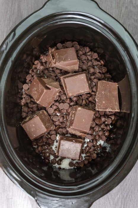 Slow Cooker Almond Joy Candy - an easy homemade candy bar with just 4 ingredients. Best of all, this recipe is made entirely in the crock-pot and tastes just like your favorite Almond Joy Candy Chocolate Bars. Just dump and go - SO EASY!!