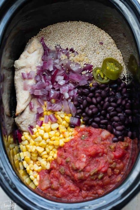 Overhead view of ingredients for Slow Cooker Chicken Enchilada Quinoa Soup in a slow cooker