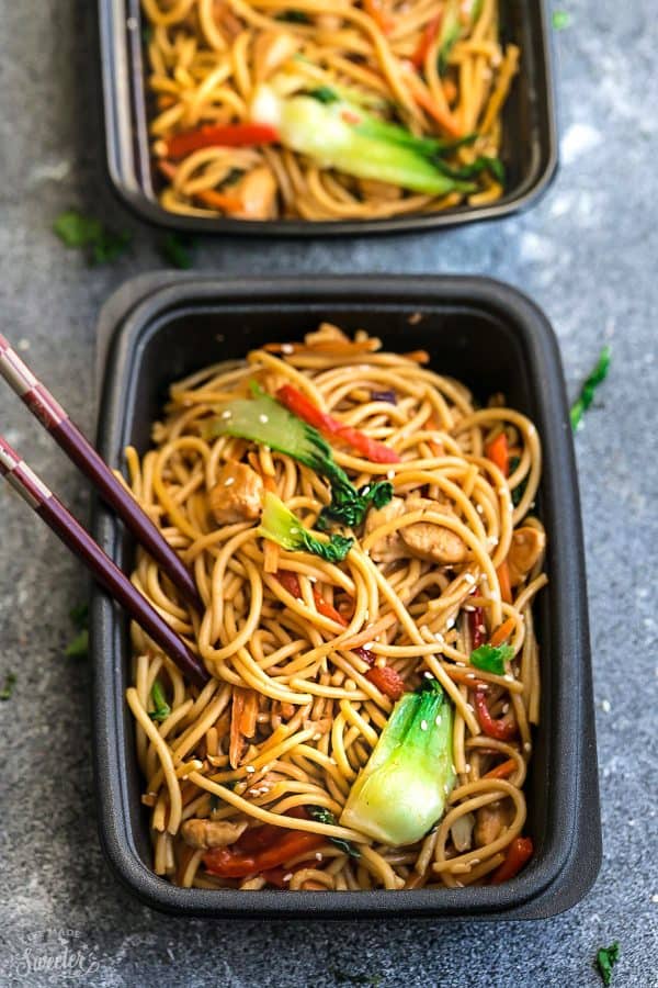 Storage containers filled with chicken lo mein noodles and chopsticks.