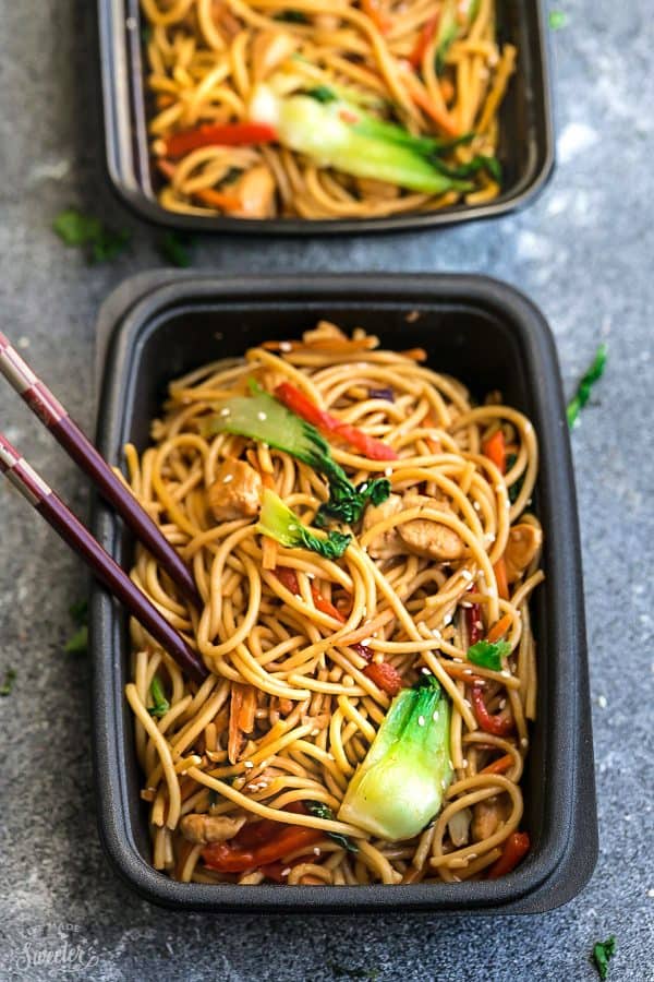 Top view of a meal prep container of Slow Cooker Chicken Lo Mein with chopsticks