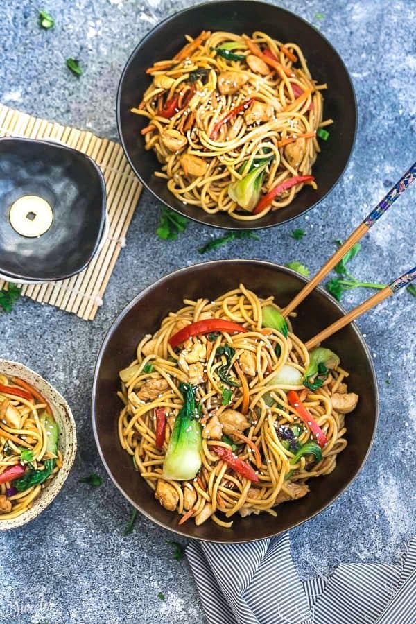 Top view of two bowls of Crock pot Slow Cooker Chicken Lo Mein with chopsticks