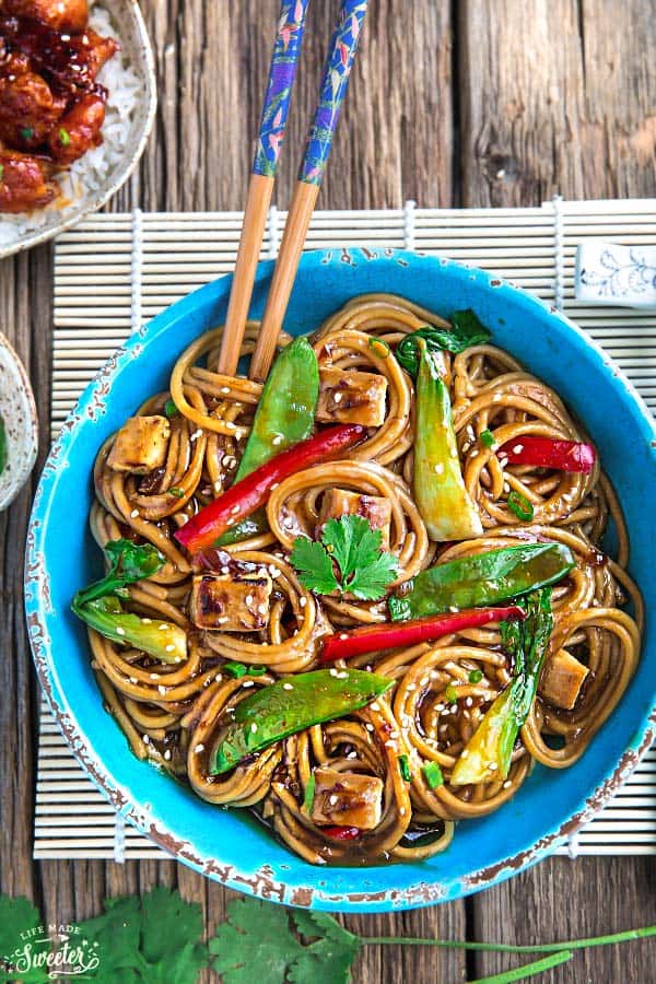 Top view of a serving of Crock pot Slow Cooker Chicken Lo Mein in a bowl with chopsticks