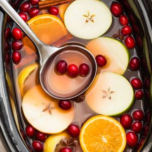This Homemade Crock Pot (Slow Cooker) Apple Cider Recipe is the perfect easy drink for fall and the holiday season. Best of all, made entirely from scratch in the crock-pot with apples, orange, lemon, cranberries, cinnamon and cloves. Set and forget and makes your house smell amazing! Warm up with a mug by a cozy fireplace.
