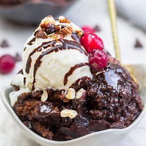 Slow Cooker Hot Fudge Pudding Cake an easy crock-pot dessert perfect for freeing up your oven. With a delicious sauce that forms beneath the cake and best part of all is how easy it is to customize with 4 fun toppings like an ice cream sundae! Plus a step-by-step video!