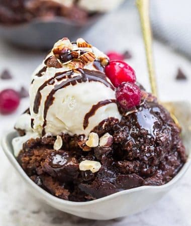 Slow Cooker Hot Fudge Pudding Cake an easy crock-pot dessert perfect for freeing up your oven. With a delicious sauce that forms beneath the cake and best part of all is how easy it is to customize with 4 fun toppings like an ice cream sundae! Plus a step-by-step video!