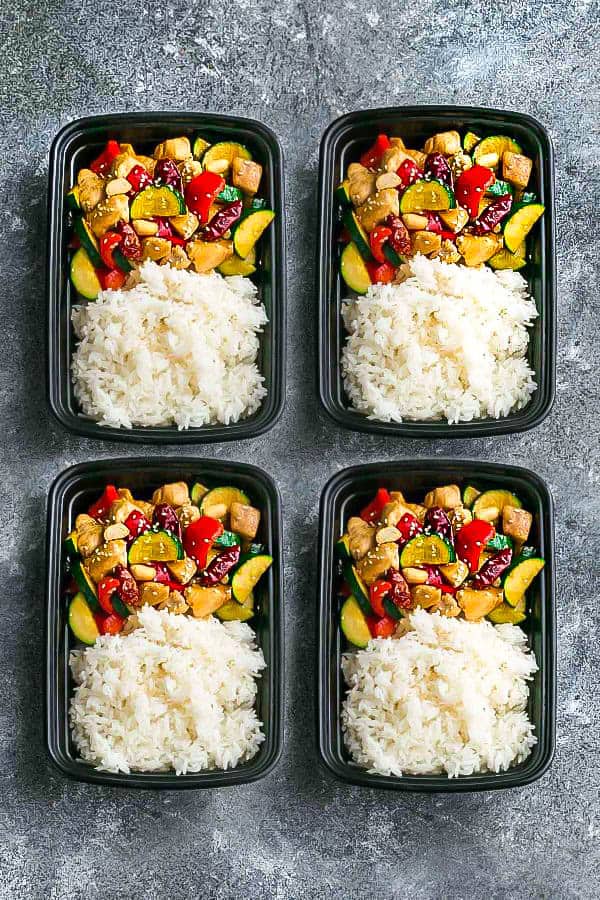 meal prep containers holding homemade Kung Pao chicken and fluffy white rice