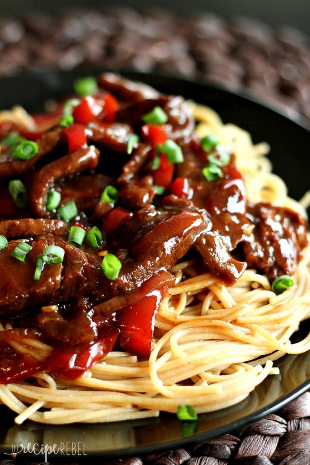 Slow cooker Mongolian Beef over spaghetti on a plate