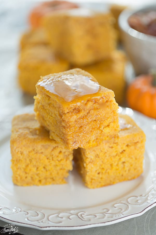 Three squares of Slow Cooker Pumpkin Cornbread stacked on a plate