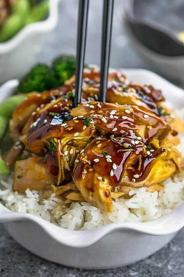 Close up view of slow cooker teriyaki chicken in white bowl. 