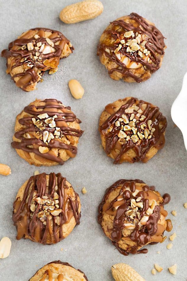 Snickers Thumbprint Cookies on parchment paper