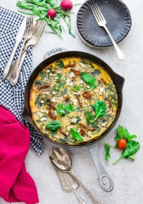 Top view of Spinach Frittata with Sun-Dried Tomatoes in a Grey Cast Iron Skillet Pan