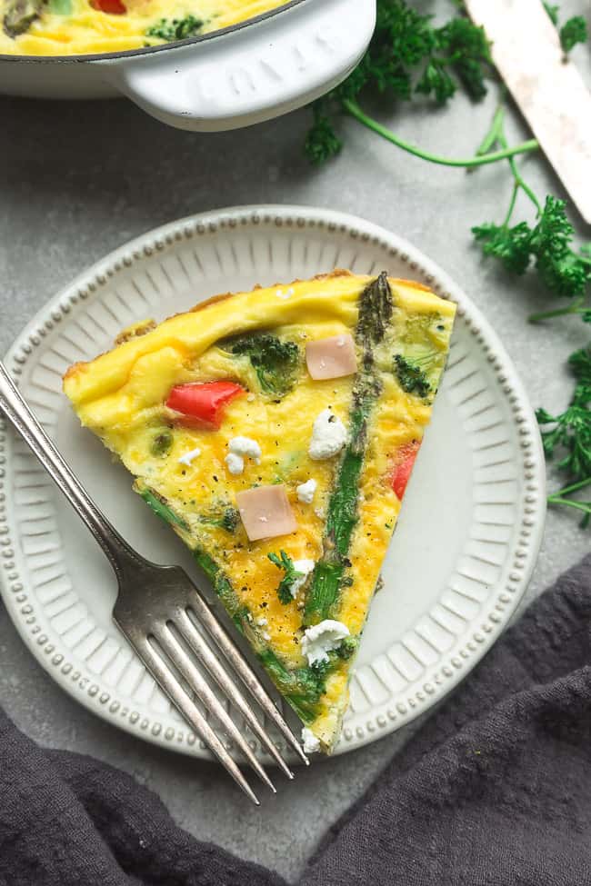Low Carb Frittata is packed with asparagus, diced ham, bell peppers, cheddar and goat cheese and perfect for a spring breakfast, brunch or dinner. Best of all, this recipe is gluten free and keto friendly.