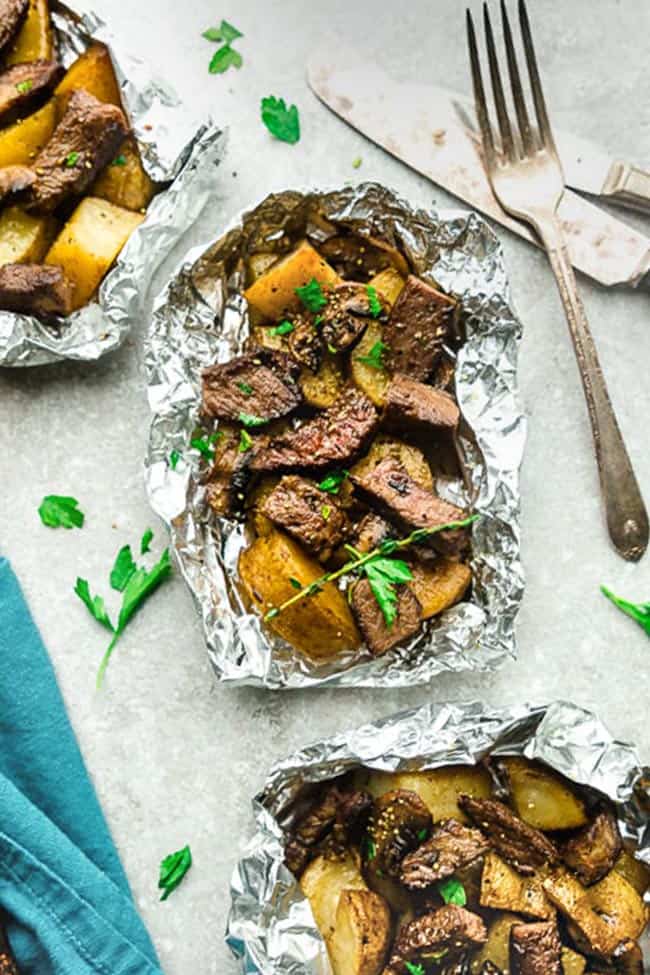 Steak and Potatoes Foil Packets are full of flavor with mushrooms, garlic, butter, herbs and perfect for busy weeknights. Best of all, instructions to make these in the oven and the grill.