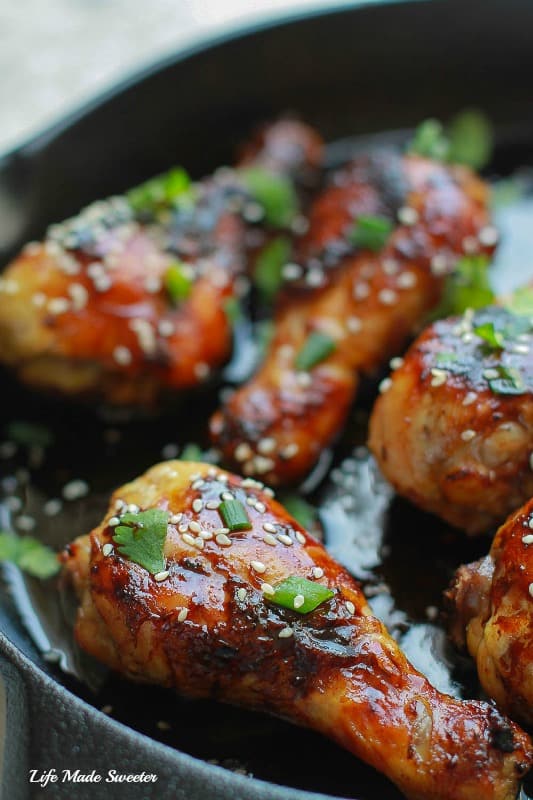 Close-up of Sticky Honey Sriracha Chicken Drumsticks in a skillet