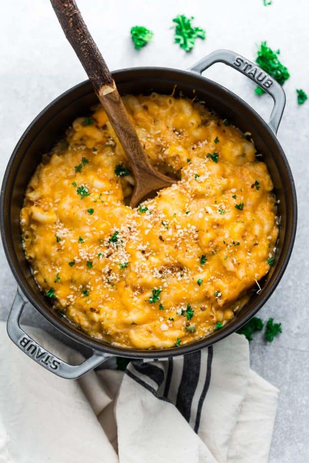 wooden spoon in a pot of creamy homemade mac and cheese