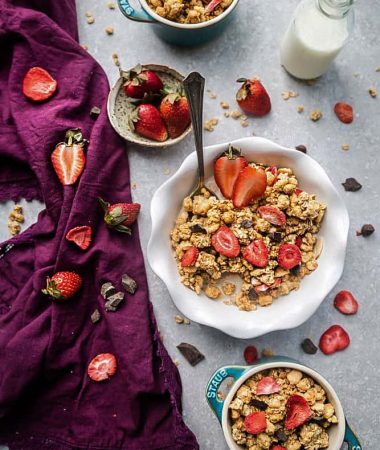 Strawberry Double Chocolate Granola makes the perfect gluten free breakfast or after school / pre or post workout snack. Loaded with crunchy clusters, shredded coconut, white and dark chocolate chips along with freeze-dried and fresh strawberries. Best of all, this recipe is gluten free and refined sugar free and works great for Sunday meal prep.
