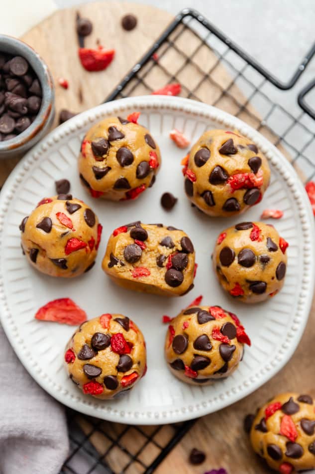 Overhead view of Strawberry Protein Balls with chocolate chips on a white plate