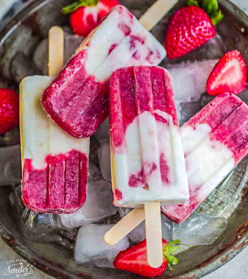 Top view of strawberry popsicles with fresh strawberries.