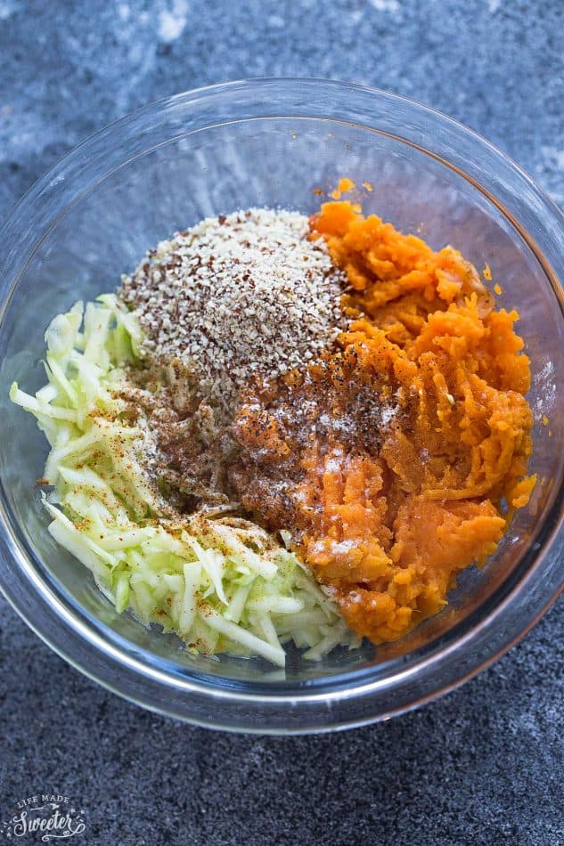 Paleo Sweet Potato Zucchini Tot ingredients in a clear glass mixing bowl.