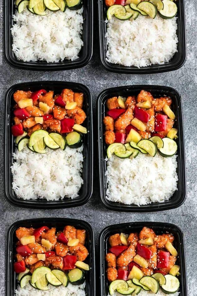 meal prep containers filled with Instant Pot Sweet and Sour Chicken, zucchini, and white rice
