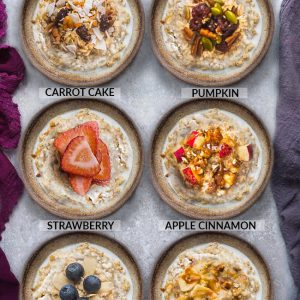 Top view of six steel cut oats bowls with different toppings on a grey background and napkins