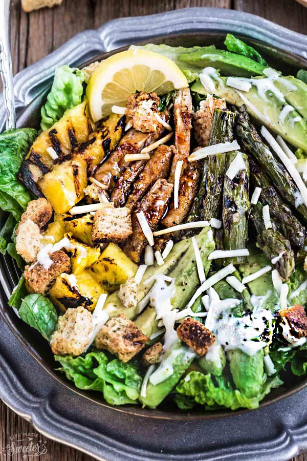 Close-up of Teriyaki Chicken Caesar Salad on a black plate