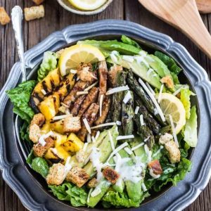 Top view of Teriyaki Chicken Caesar Salad on a black plate