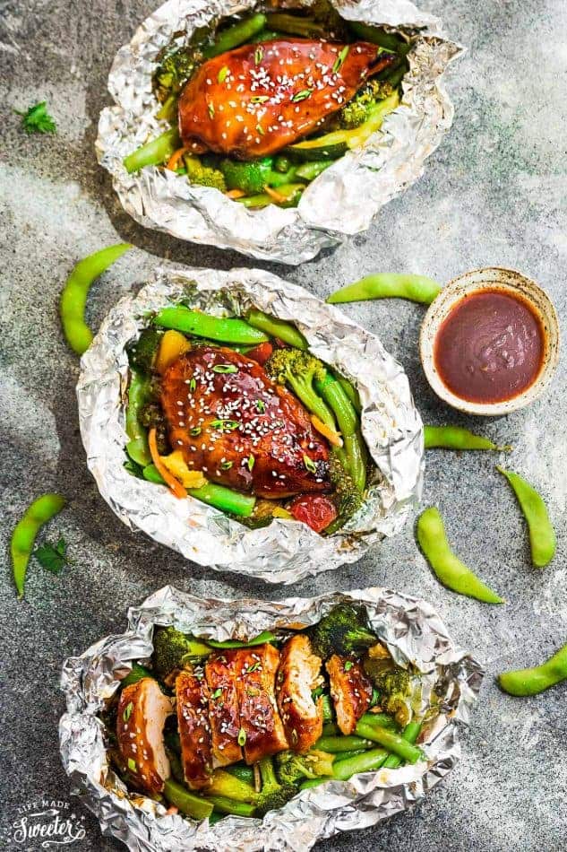 This recipe for Teriyaki Chicken Foil Packets with Vegetables is the perfect easy campfire or weekly dinner for summer. A complete meal with practically no clean up and full of your favorite sweet and savory Asian-inspired meal with tender chicken, edamame, broccoli, pineapple and red bell pepper. Make a batch for Sunday meal prep and pack it up for your lunchbox or lunch bowls. Foil packets are great for camping or busy weeknights.