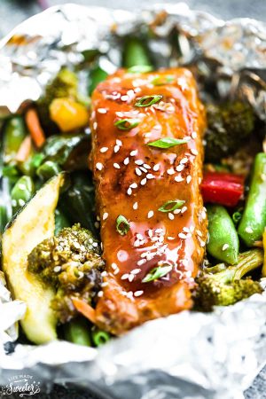 This recipe for Teriyaki Salmon Foil Packets with Vegetables is the perfect easy campfire or weekly dinner for summer. A complete meal with practically no clean up and full of your favorite sweet and savory Asian-inspired meal with perfectly tender and flaky salmon, edamame, broccoli, pineapple and red bell pepper. Make a batch for Sunday meal prep and pack it up for your lunchbox or lunch bowls. Foil packets are great for camping or busy weeknights.