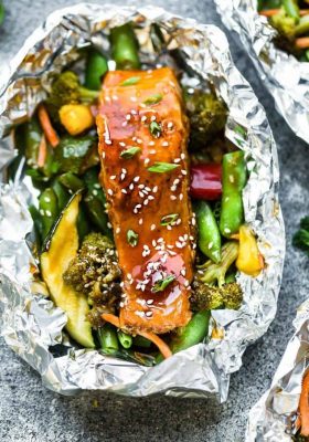 This recipe for Teriyaki Salmon Foil Packets with Vegetables is the perfect easy campfire or weekly dinner for summer. A complete meal with practically no clean up and full of your favorite sweet and savory Asian-inspired meal with perfectly tender and flaky salmon, edamame, broccoli, pineapple and red bell pepper. Make a batch for Sunday meal prep and pack it up for your lunchbox or lunch bowls. Foil packets are great for camping or busy weeknights.