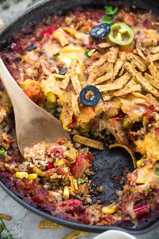 Skillet Tex Mex Casserole in a skillet with a couple scoops removed