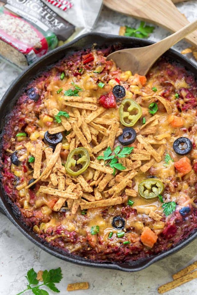 Skillet Tex Mex Casserole in a skillet with a wooden spoon