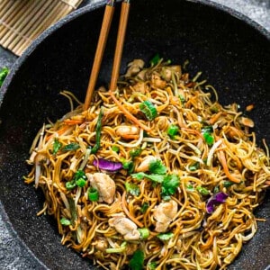 Top view of Chicken Chow Mein in a wok with chopsticks