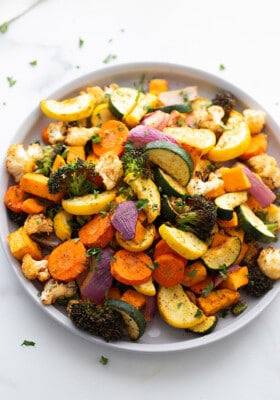 Air fried zucchini, carrots, broccoli and cauliflower in clear mixing bowl