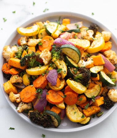 Air fried zucchini, carrots, broccoli and cauliflower in clear mixing bowl